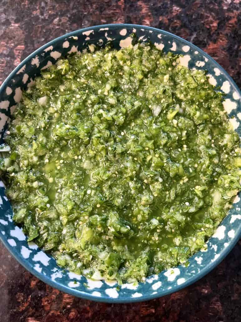 A bowl of fresh homemade tomatillo salsa verde, ready to be served.