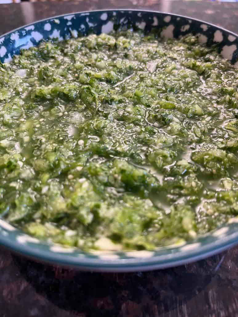 Side view of a bowl filled with freshly made tomatillo salsa verde.