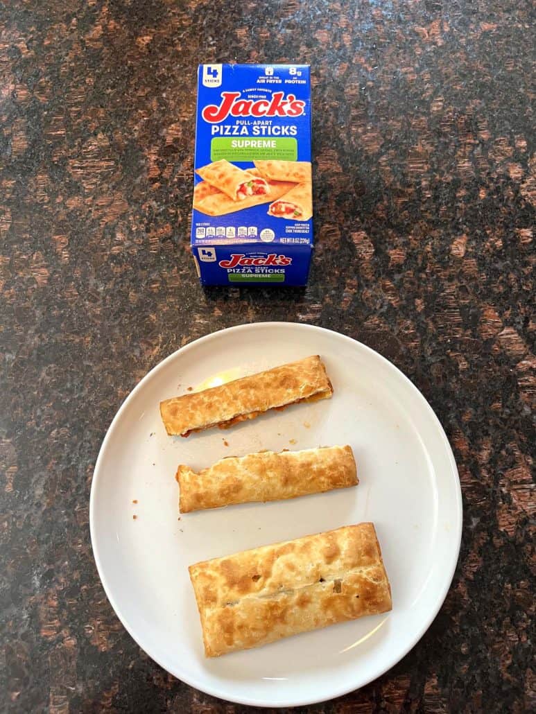 Plate of crispy, golden pizza sticks served alongside the box of Jack’s Supreme Pizza Sticks, ready to enjoy.