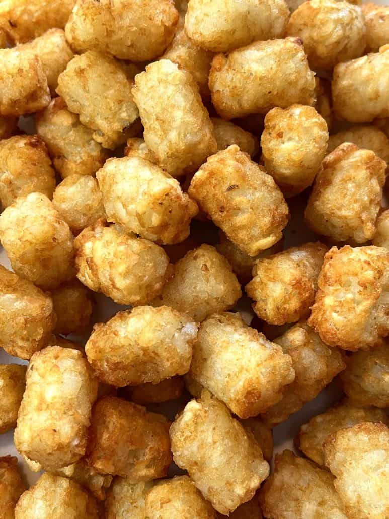 Close-up of a pile of crispy, golden Sonic tater tots, perfectly cooked and ready to enjoy.