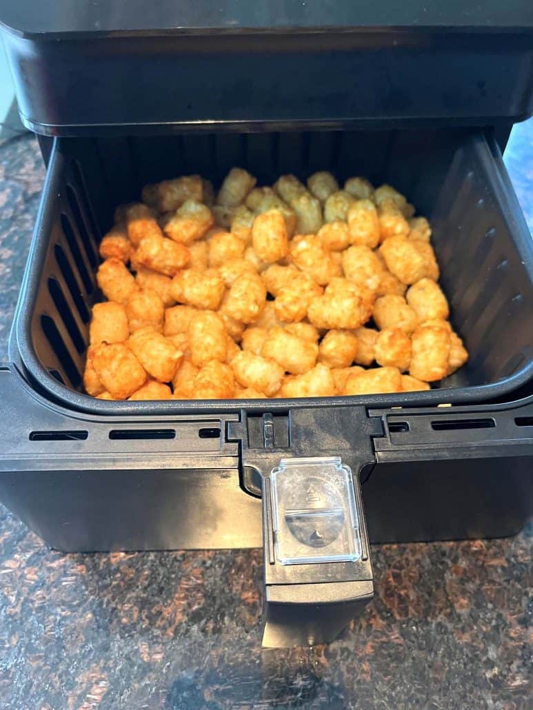 Golden, crispy Sonic tater tots freshly cooked in the air fryer basket.