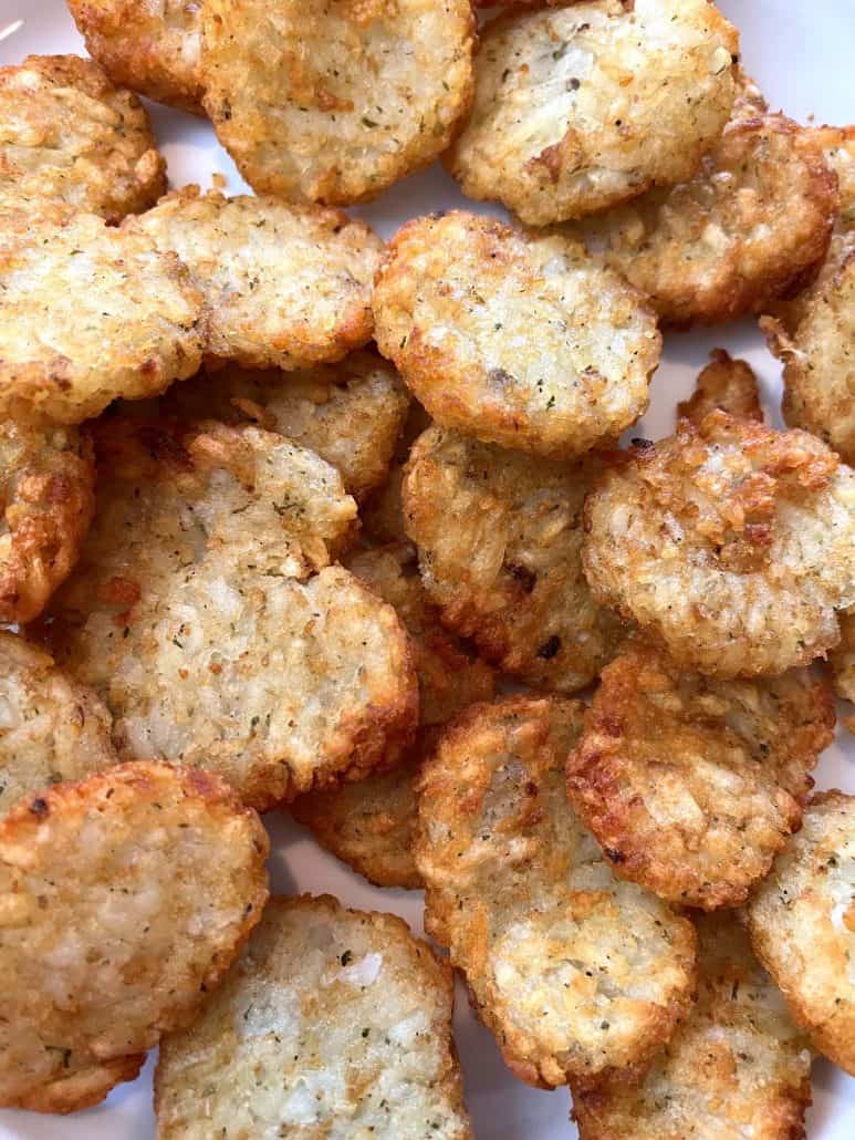 Pile of crispy, golden McCain Baby Cakes Hashbrowns on a plate, highlighting their perfectly cooked texture.