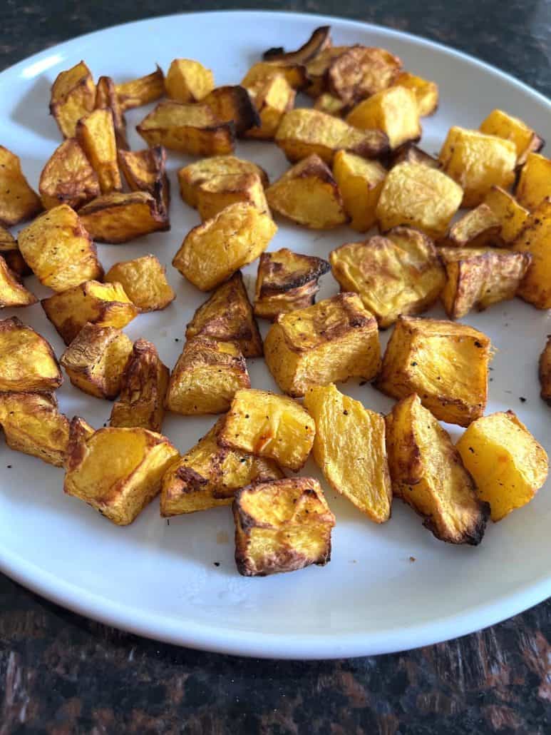 Delicious and easy homemade, air-fried pumpkin cubes on a white plate.