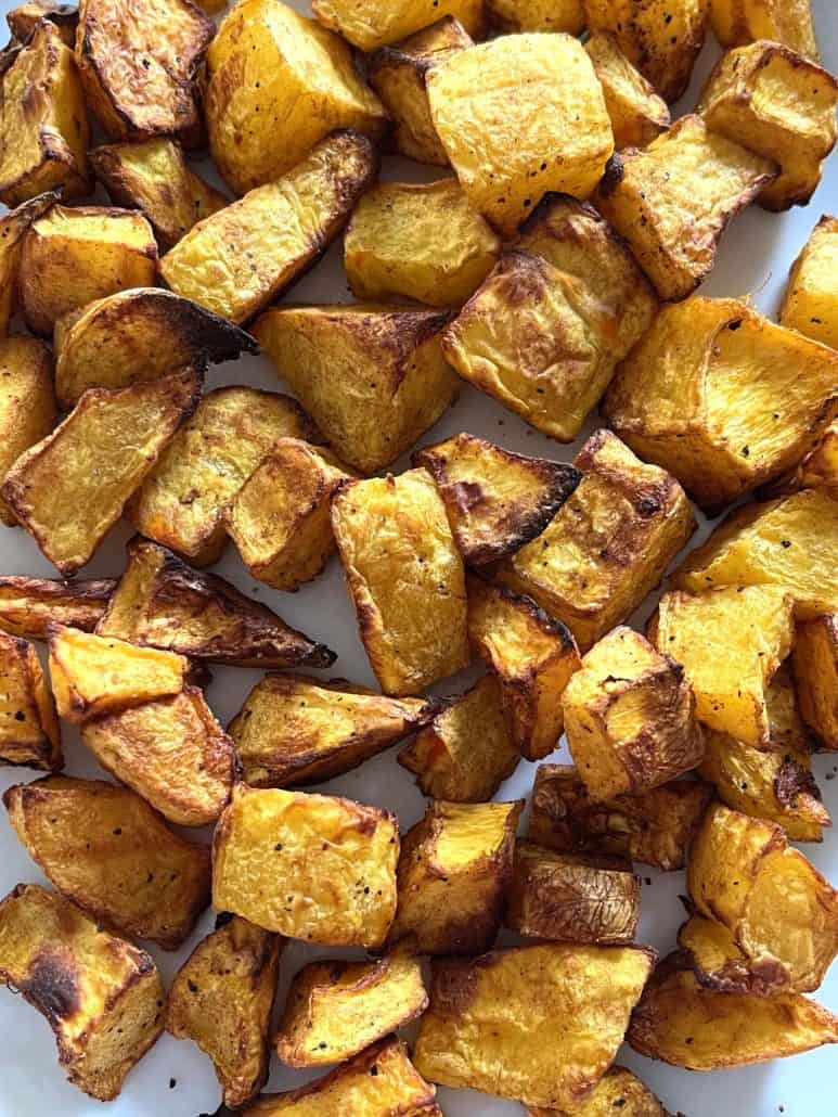 Close-up of golden, crispy air-fried pumpkin cubes on a plate ready to enjoy.