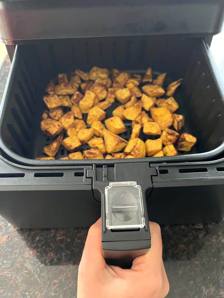 Crispy air-fried pumpkin cubes fresh out of the air fryer.