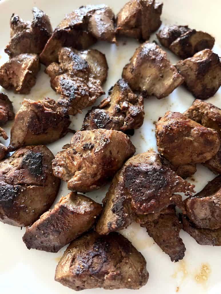 Plate filled with crispy, golden-brown pieces of sauteed chicken liver, ready to enjoy.