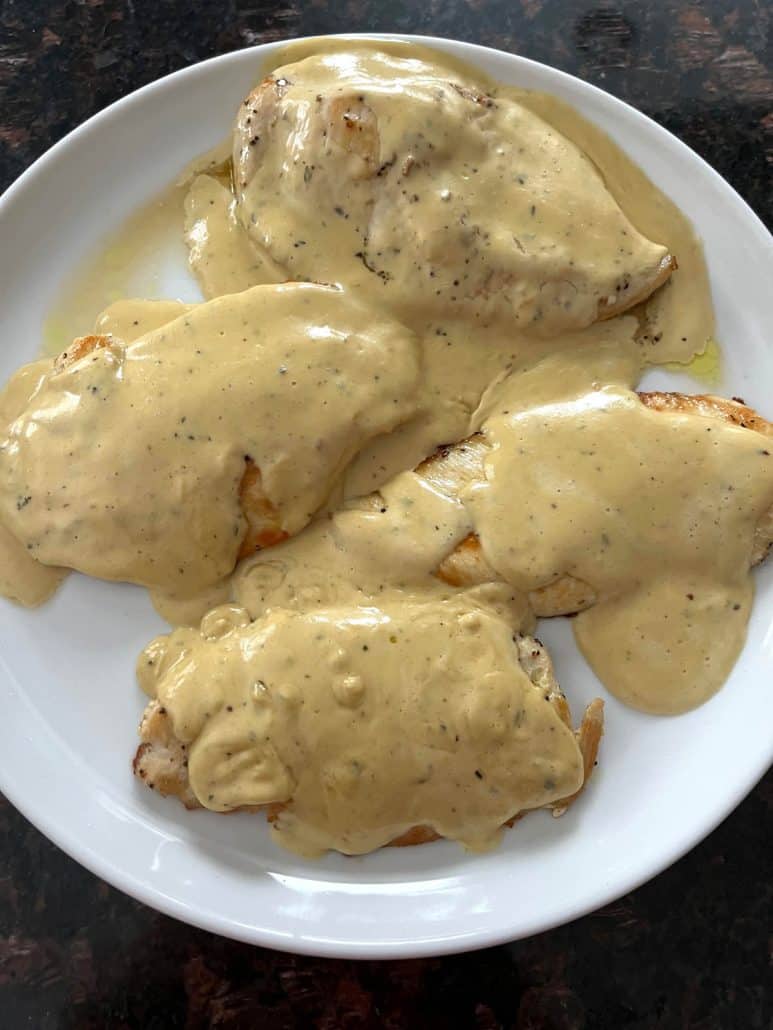 Plate of tender chicken breasts smothered in creamy Dijon mustard sauce, showcasing the rich and flavorful result of the easy Dijon Mustard Chicken recipe.