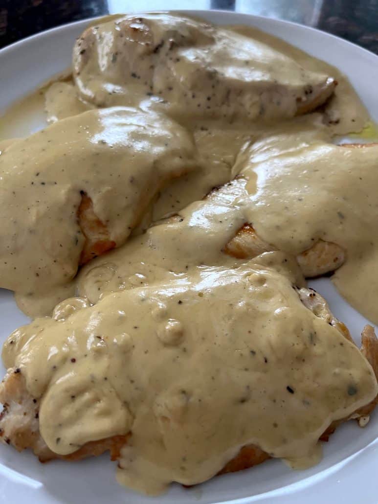 Angle view of Dijon Mustard Chicken served on a plate, generously coated in a creamy, flavorful mustard sauce for a comforting and elegant meal.