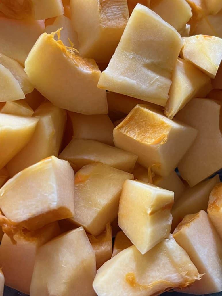 Close-up of freshly cut pumpkin cubes, prepared and ready for cooking or roasting.