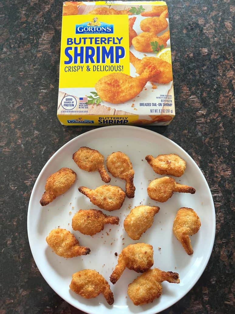 Plate of crispy butterfly shrimp served next to a box of Gorton's Butterfly Shrimp.