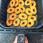 Golden, crispy White Castle chicken rings arranged in an air fryer basket, fresh out of the air fryer, ready to serve.