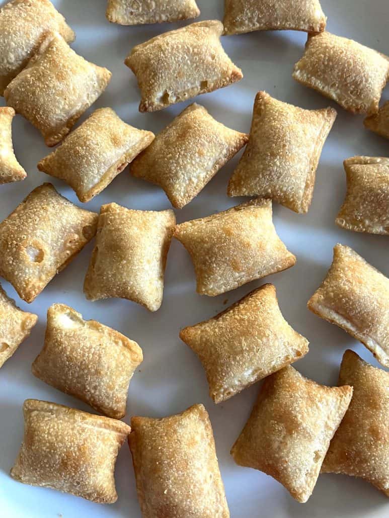 Close-up plate full of crispy golden Totino's Breakfast Snack Bite, ready to enjoy as a delicious snack or breakfast treat.