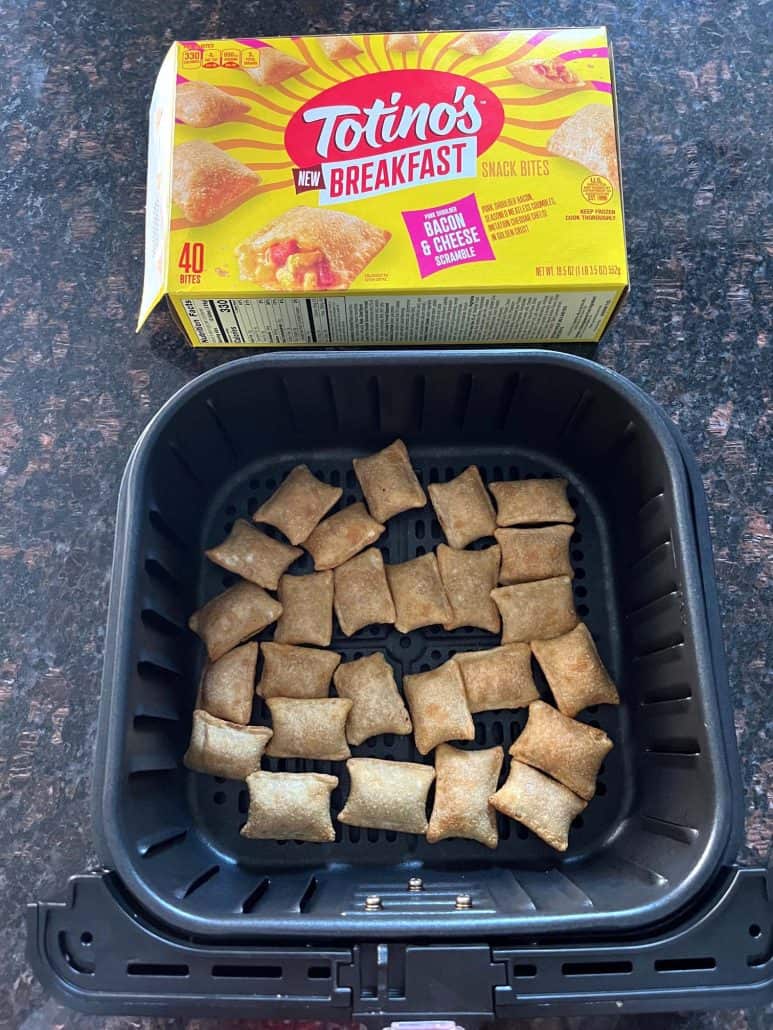 Air fryer basket filled with Totino's Breakfast Snack Bites placed in a single layer, with the product box displayed in the background.