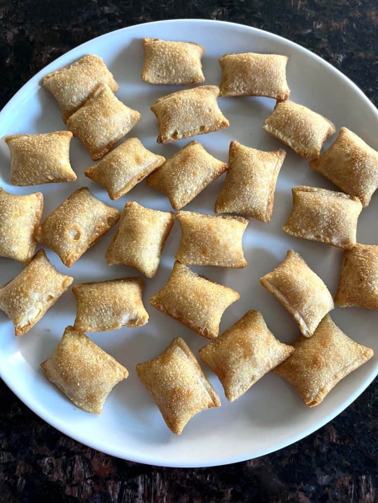 A plate piled with crispy Totino's Breakfast Snack Bites, showcasing their golden brown texture after air frying.