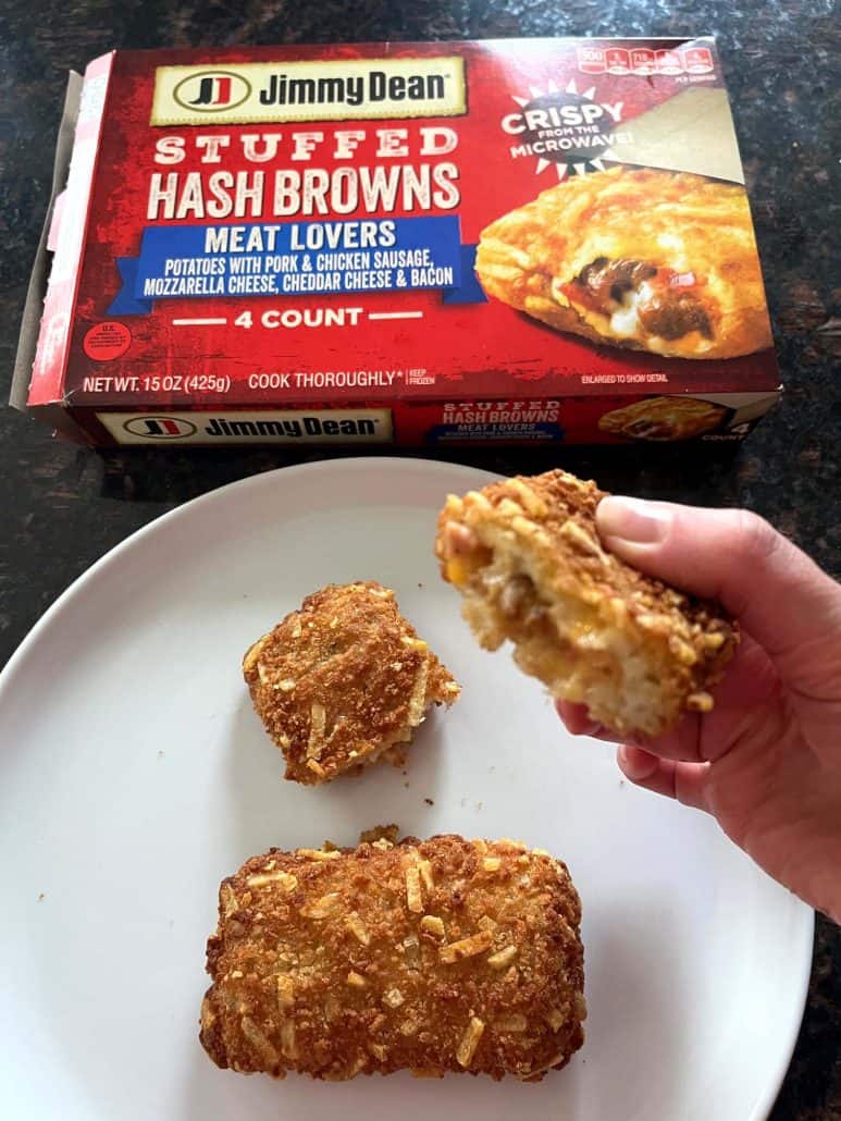 Plate with crispy Jimmy Dean stuffed hashbrowns, one held up to show the cheesy filling, with the product packaging visible in the background.