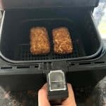 Jimmy Dean stuffed hashbrowns cooked to golden perfection in an air fryer basket.