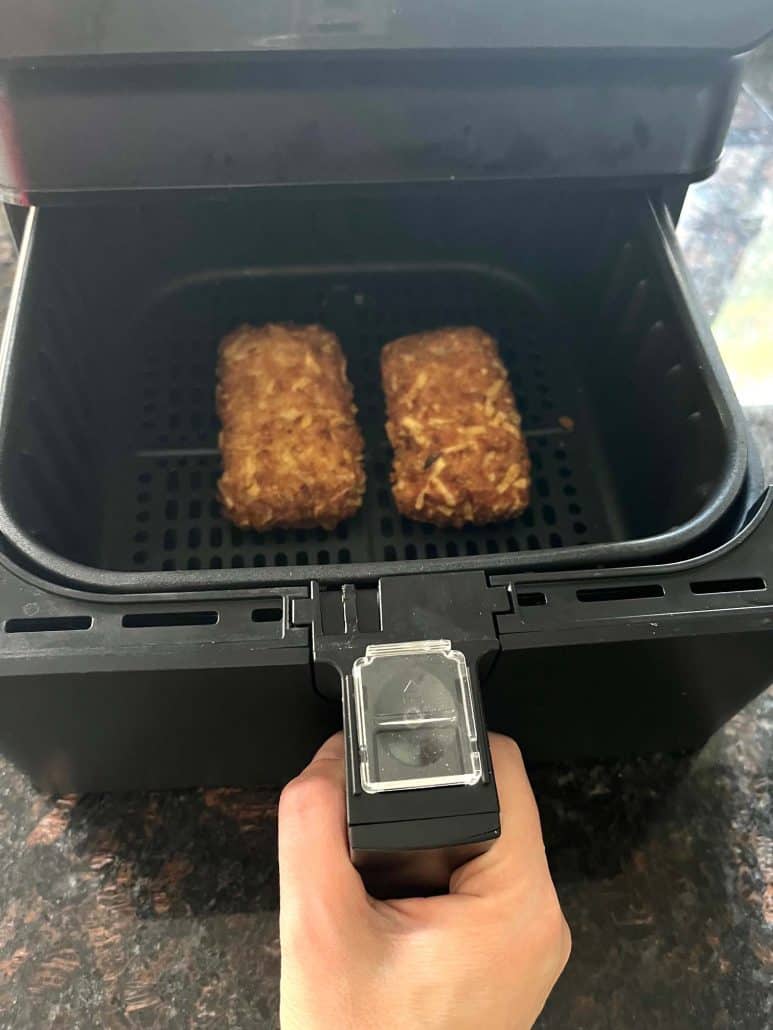 Jimmy Dean stuffed hashbrowns cooked to golden perfection in an air fryer basket.