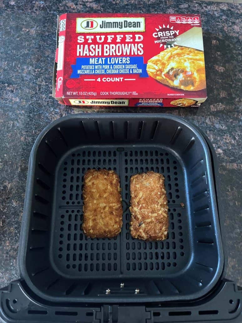 Jimmy Dean Stuffed Hash Browns package displayed above an air fryer basket with two crispy hashbrowns freshly cooked inside.