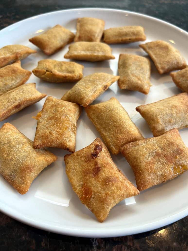 Close-up of a white plate filled with crispy, golden-brown White Castle Cheeseburger Bites, highlighting their bite-sized shape and appetizing texture, perfect for snacking or sharing.