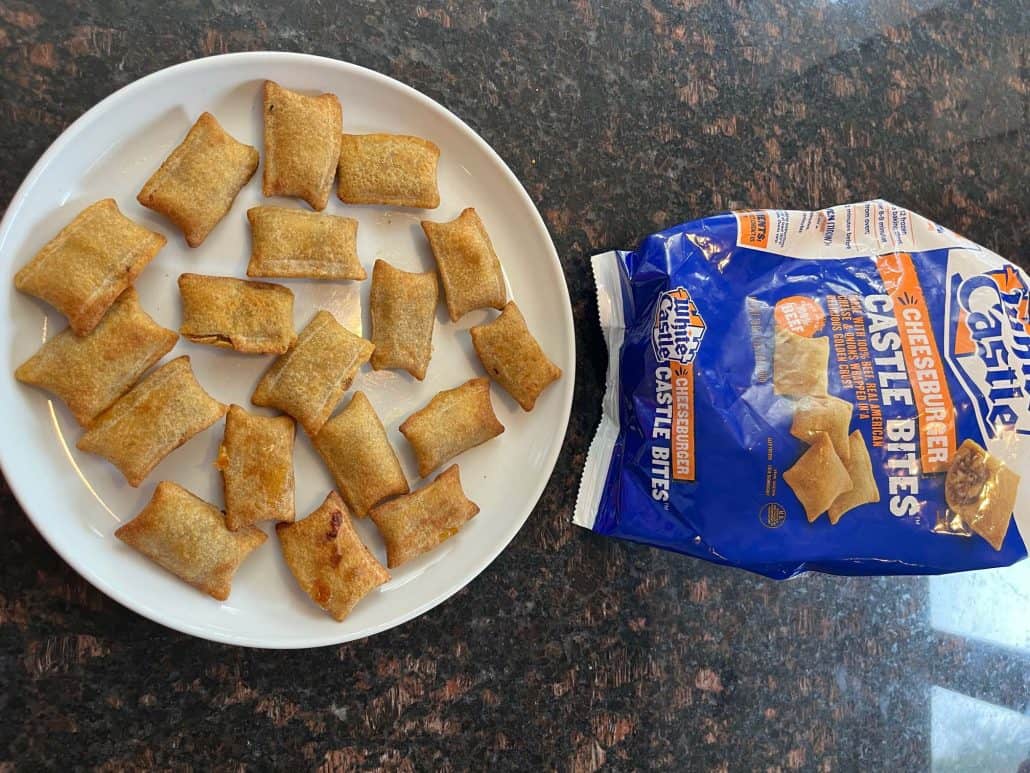 Plate of golden-brown White Castle Cheeseburger Bites arranged neatly next to the opened branded package.