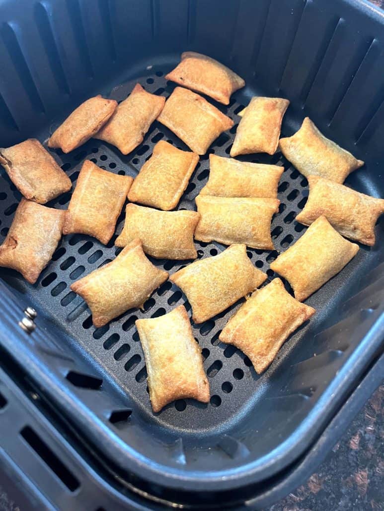 Angled view of an air fryer basket filled with evenly spaced, golden-brown White Castle Cheeseburger Bites, highlighting their crispy texture and perfect preparation for a quick snack or meal.