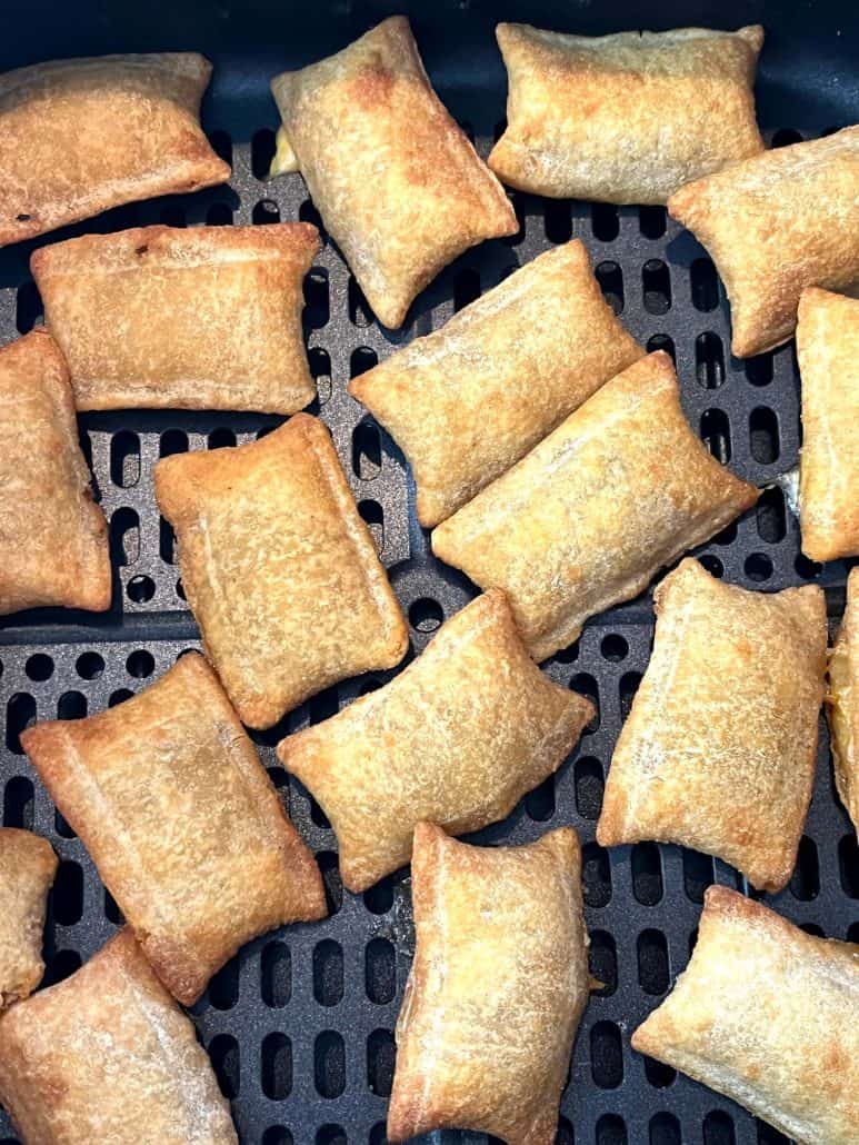 Close-up of golden-brown White Castle Cheeseburger Bites inside an air fryer basket, showcasing their crispy texture and evenly cooked appearance, ready to enjoy as a quick snack or meal.