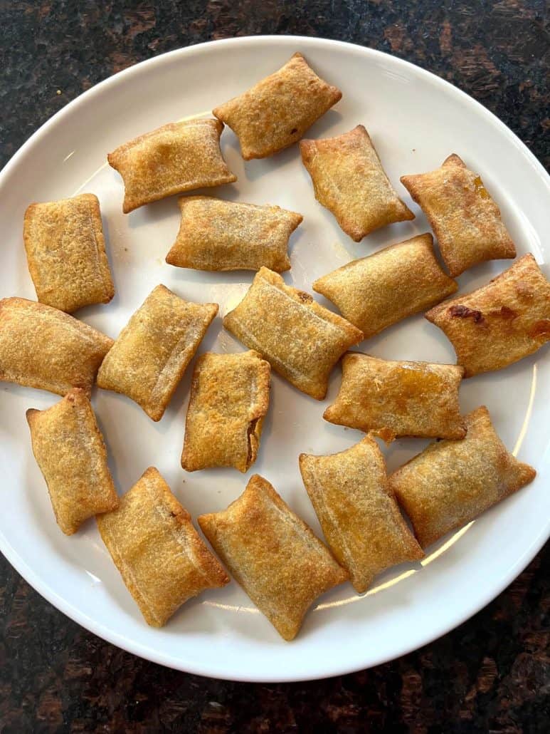 White plate filled with golden-brown White Castle Cheeseburger Bites, arranged neatly to showcase their crispy, bite-sized appeal, perfect for serving as a snack or appetizer.