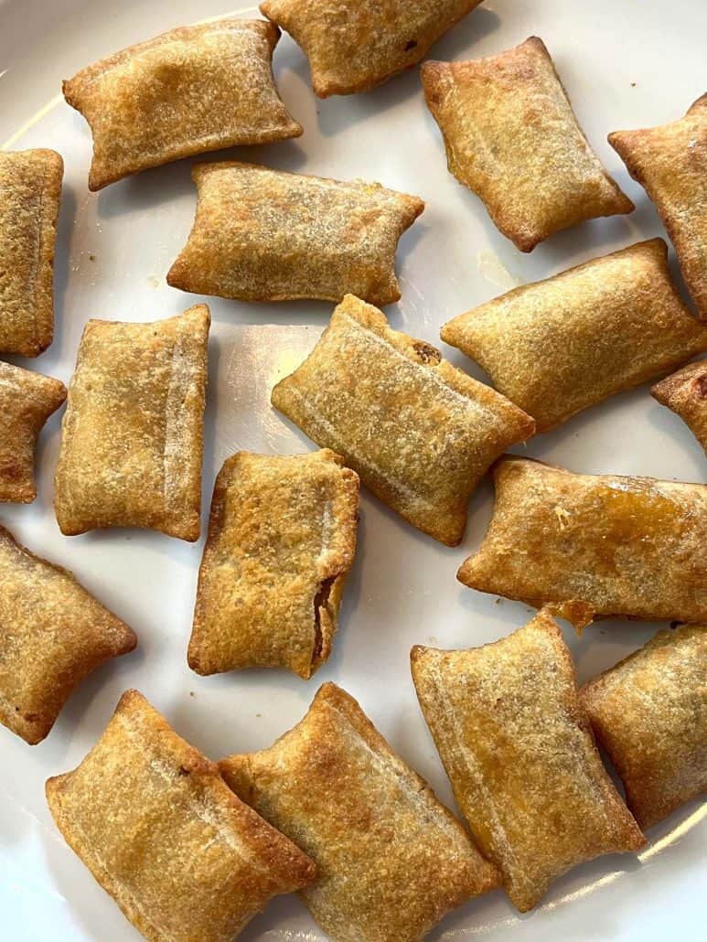 Close-up of golden-brown White Castle Cheeseburger Bites on a white plate, showcasing their crispy texture and compact, snackable size.