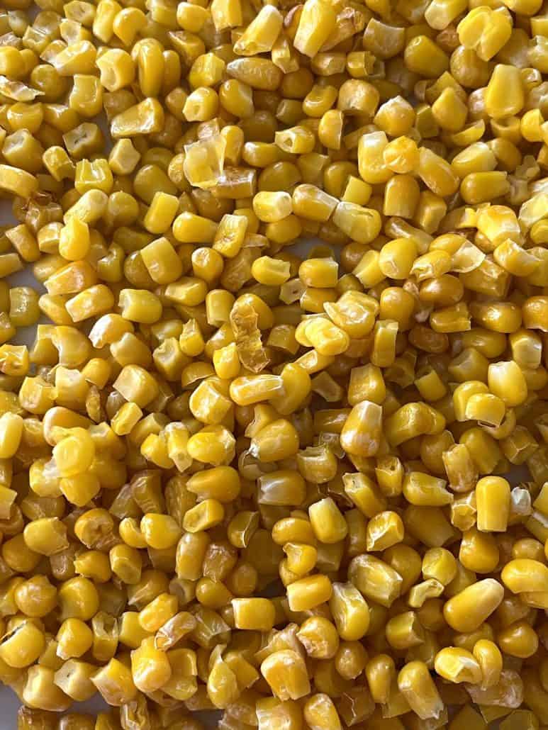 Close-up of golden air fryer corn, showing the crispy texture of this easy frozen corn recipe cooked to perfection.