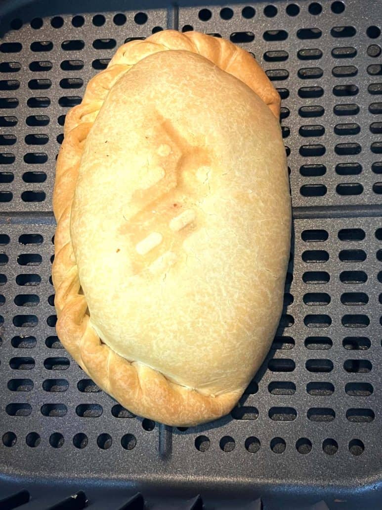 A perfectly cooked golden-brown pasty, ready to be enjoyed.