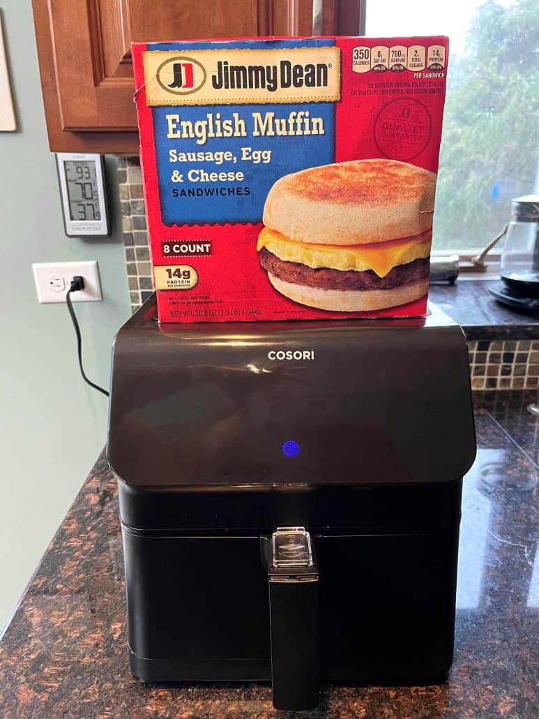 Box of Jimmy Dean English Muffin Sandwiches placed on top of an air fryer, ready to be cooked.