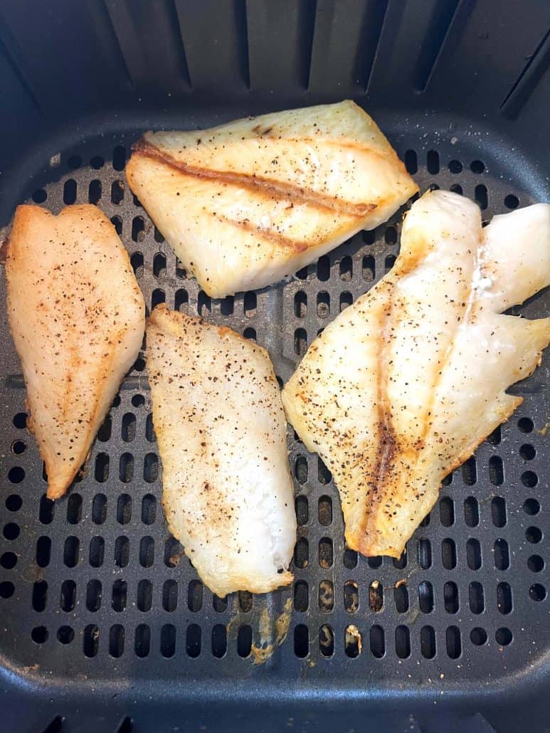 Close-up of perfectly air-fried orange roughy fillets, seasoned and cooked to a golden brown.