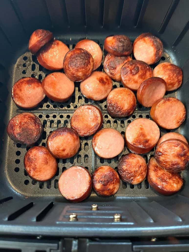 Crispy, golden-brown ring bologna slices freshly cooked in the air fryer.