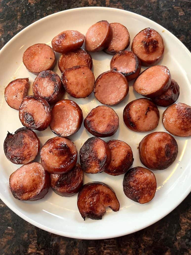 A plate of crispy, golden-brown air-fried ring bologna slices, ready to be served as a tasty appetizer or main dish.