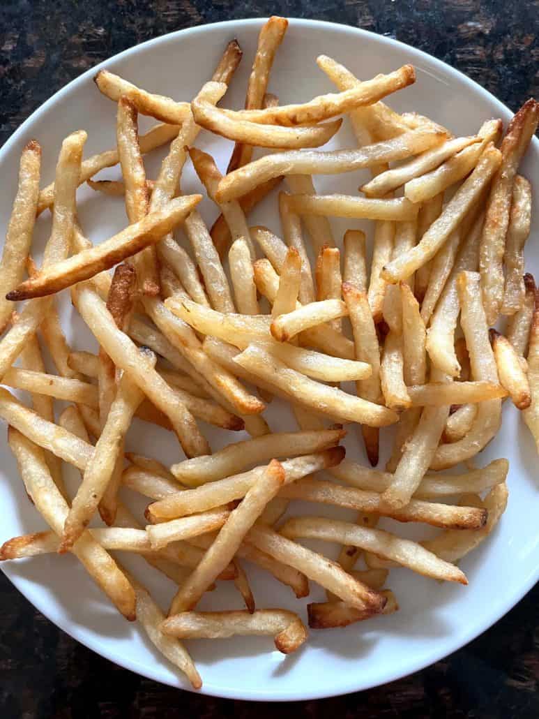 Crispy McCain Beer Battered Fries served on a white plate, ready to enjoy.